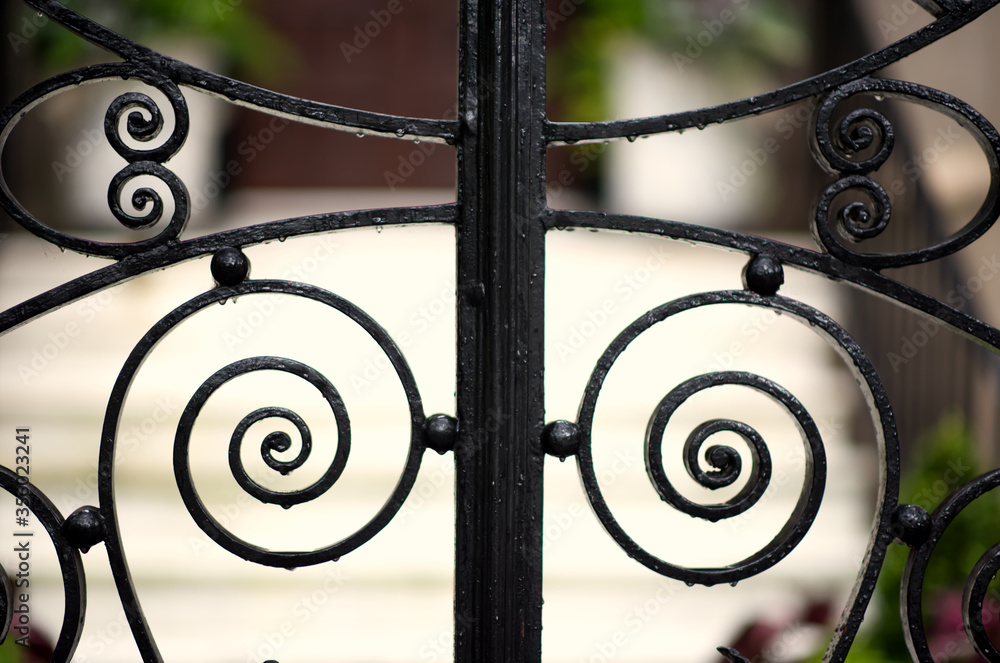 Parts of very old wrought iron gates. Stock Photo Adobe Stock