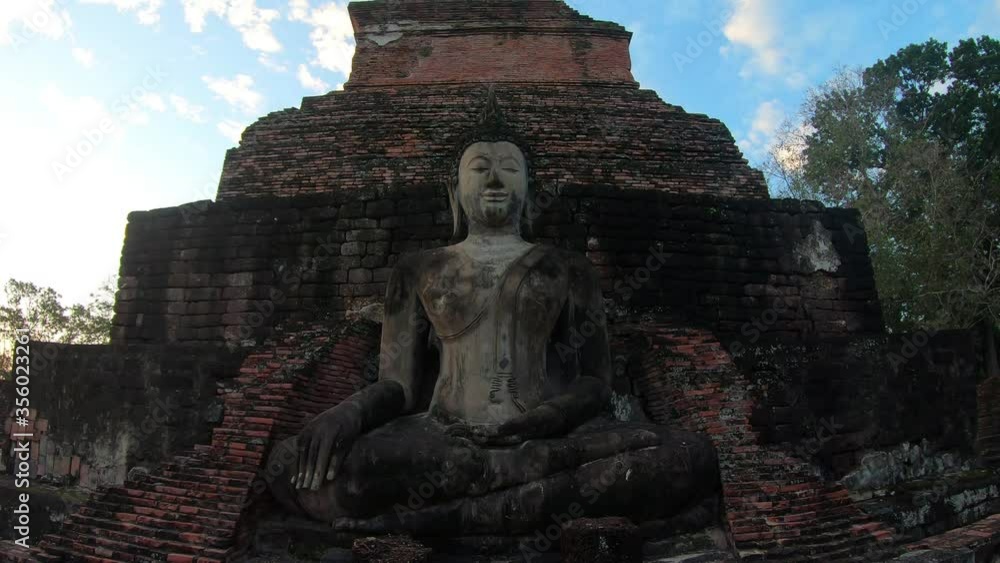 4k Mahathat temple in Sukhothai historical park;Thailand.Seated Buddha(Phra Atchana) at Wat Si Chum temple in Sukhothai Historical Park; a UNESCO world heritage site; Thailand. 4k Mahathat temple in Sukhothai historical park;Thailand.Seated Buddha(Phra Atchana) at Wat Si Chum temple in Sukhothai Historical Park; a UNESCO world heritage site; Thailand.