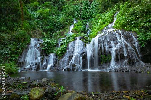 Waterfall landscape. Beautiful hidden waterfall in tropical rainforest. Nature background. Slow shutter speed  motion photography. Pucak Manik waterfall  Bali  Indonesia