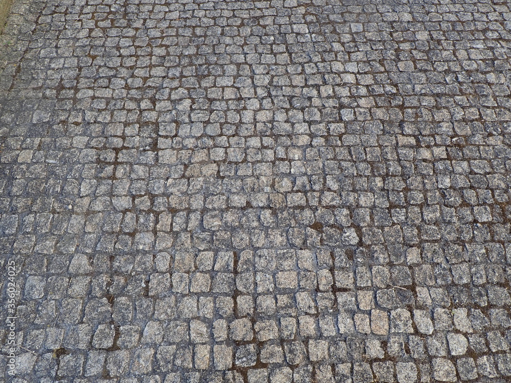 square cobblestone road or path or bricks on ground