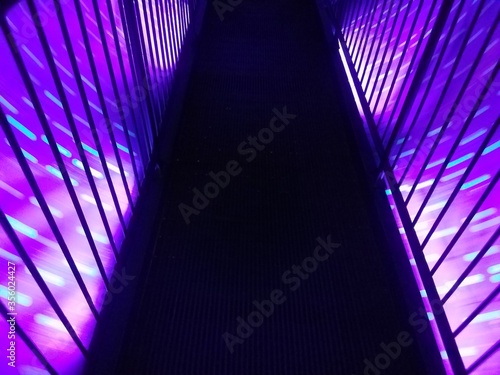 spinning purple light tunnel with walkway