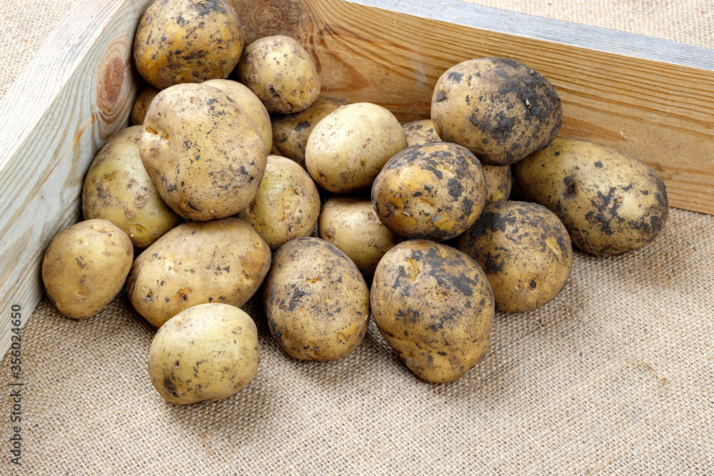 Potatoes for sale in a corner of a wooden box Potatoes for sale in a corner of a wooden box