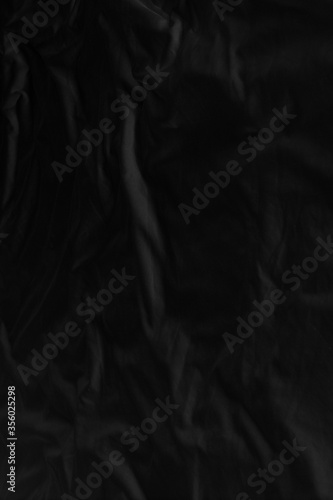 Black fabric texture for background; Abstract black fabric cloth wave or wavy folds texture material for background