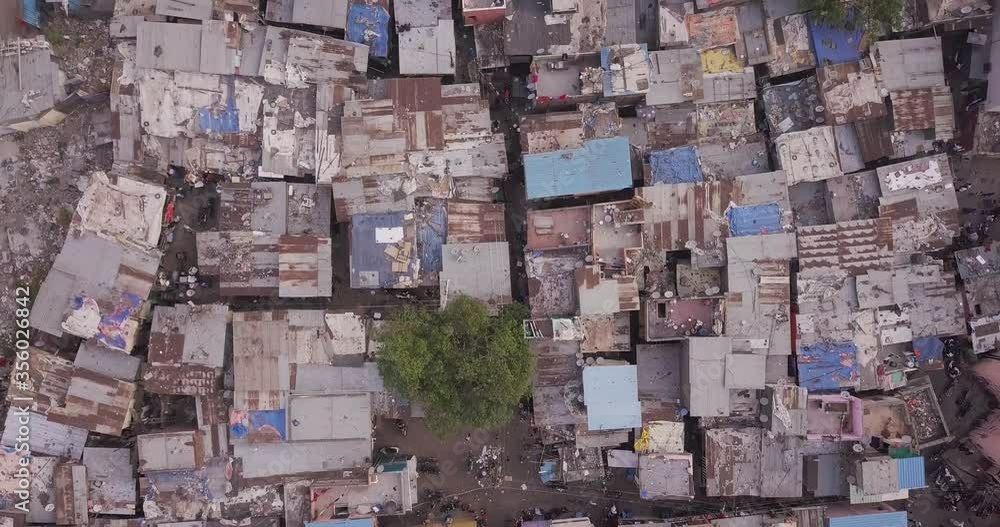 Slowly aerial fly over with top down view of self-builted indian houses in the Slum in the inner city of Pune, Maharashtra, India. 4K. Slowly aerial fly over with top down view of self-builted indian houses in the Slum in the inner city of Pune, Maharashtra, India. 4K.
