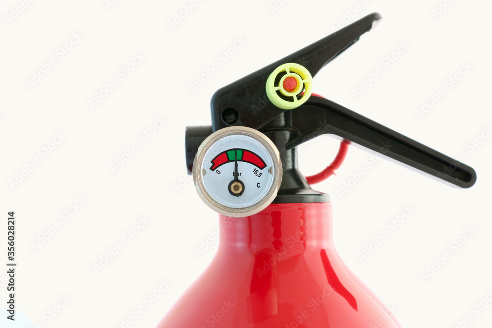 A pressure gauge on a fire extinguisher shows the correct needle