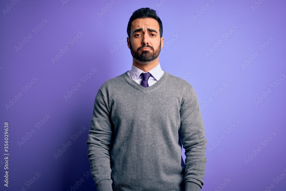 Handsome businessman with beard wearing casual tie standing over purple background depressed and worry for distress, crying angry and afraid. Sad expression. Handsome businessman with beard wearing casual tie standing over purple background depressed and worry for distress, crying angry and afraid. Sad expression.