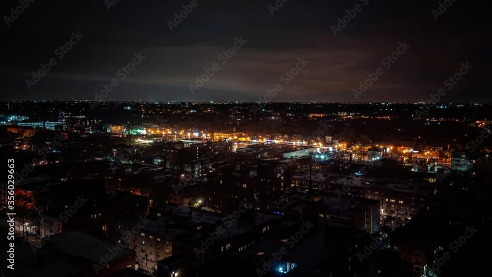 Dramatic aerial nighttime weather time lapse as an intense storm system and clouds move over the city and residential neighborhoods with Strikes of Lightning flashing and lighting up the night. Dramatic aerial nighttime weather time lapse as an intense storm system and clouds move over the city and residential neighborhoods with Strikes of Lightning flashing and lighting up the night.