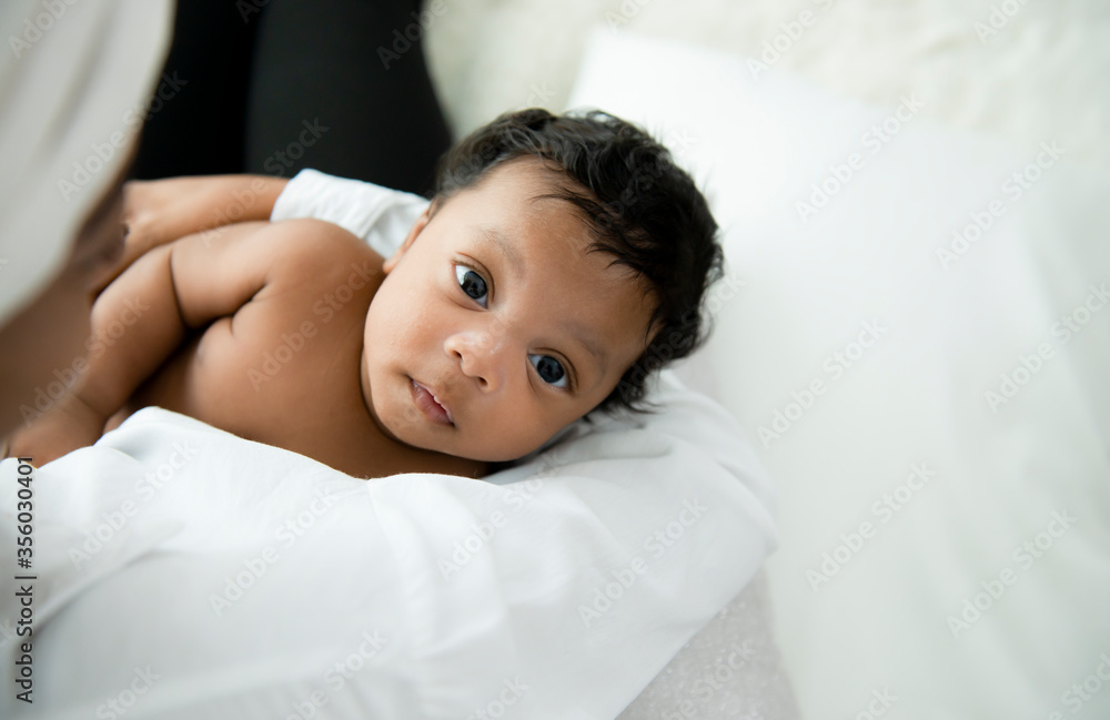 Happy African American mother holding baby boy portrait and looking at camer on white background. Adorable little african american baby boy In the embrace of mother. Happy black family with newborn. Happy African American mother holding baby boy portrait and looking at camer on white background. Adorable little african american baby boy In the embrace of mother. Happy black family with newborn.