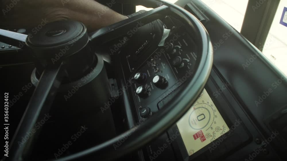 A bus driver sanitizes the dashboard A bus driver sanitizes the dashboard