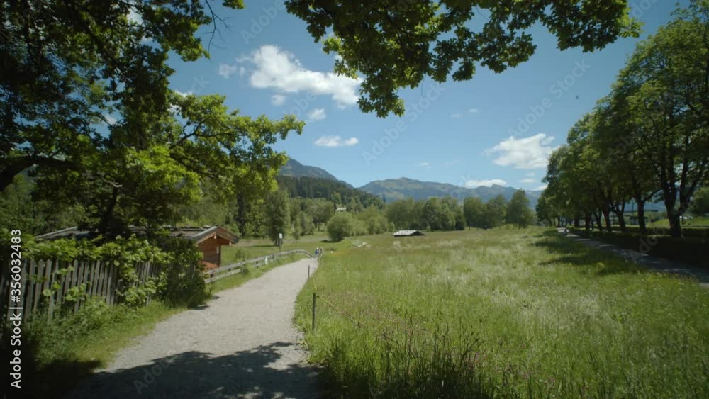 Tracking shot towards Schwarzsee Lake, with the beautiful Austrian Alps in the background on a clear sunny day Tracking shot towards Schwarzsee Lake, with the beautiful Austrian Alps in the background on a clear sunny day