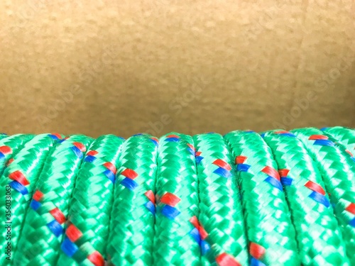 Coiled nylon rope close up against brown cardboard