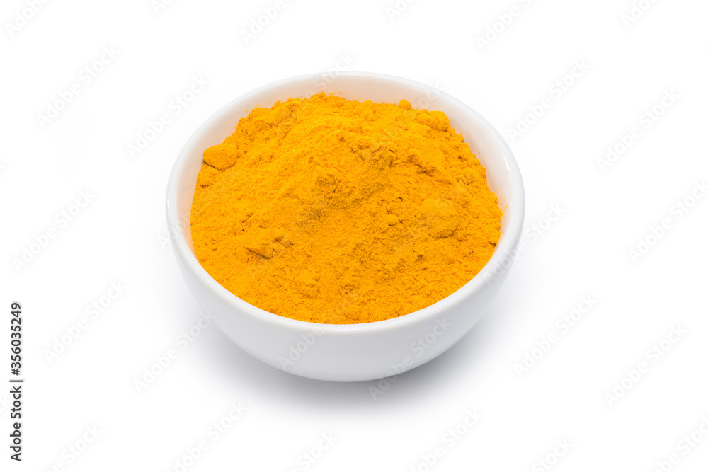 Turmeric powder in white bowl isolated on white. Clipping path. Turmeric powder in white bowl isolated on white. Clipping path.