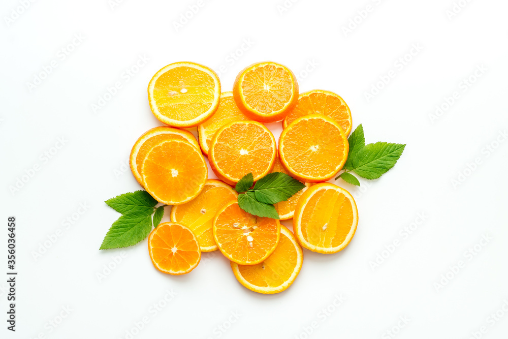 Fototapeta premium Orange slices grouped center of frame on white desk