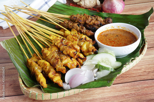 Satay is a popular Malaysia / Indonesia dish of seasoned, skewered and grilled chicken and meat, served with peanut sauce.
