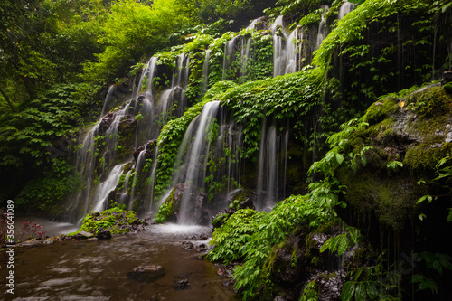 Waterfall landscape. Beautiful hidden waterfall in tropical rainforest. Nature background. Slow shutter speed  motion photography. Banyu Wana Amertha waterfall  Bali  Indonesia