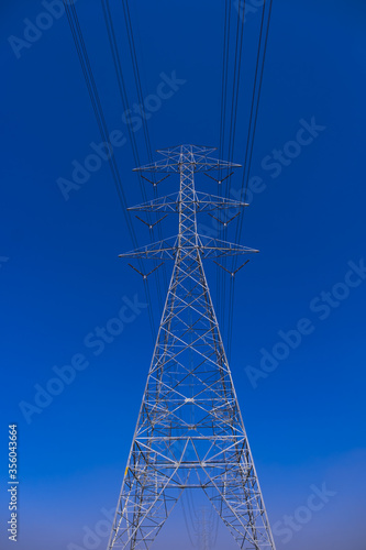 Electrical tower station wiring power with clearly blue sky background, High voltage station post