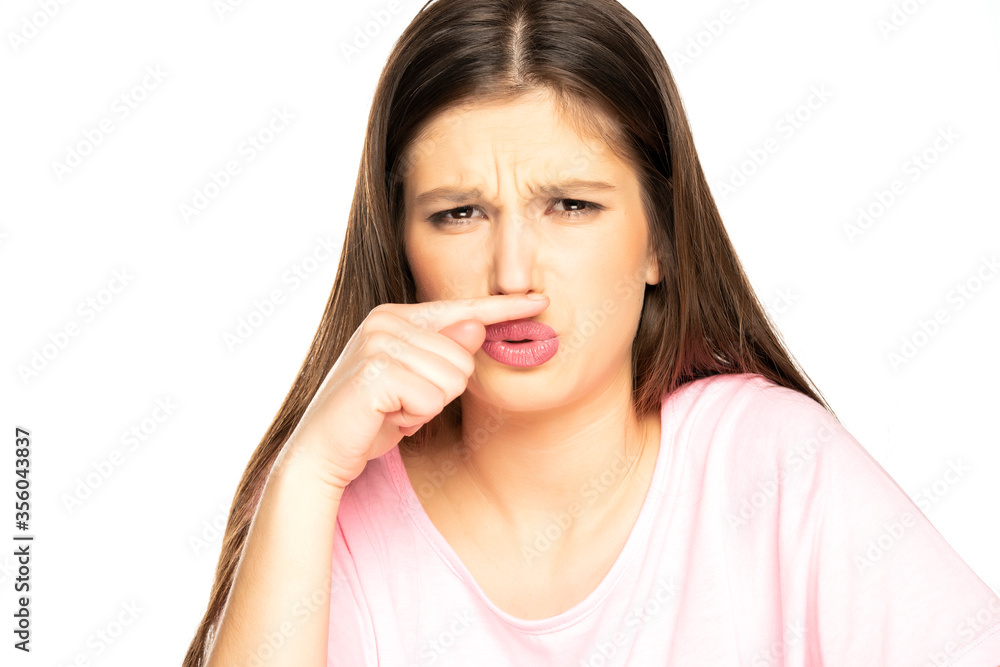 young woman with bad smell gesture young woman with bad smell gesture