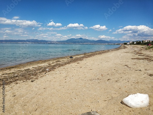 A stunning sandy beach in the area of Thessaloniki Greece. Blue summer sky with clouds.