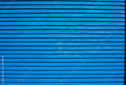 Blue wall of thin boards background or texture