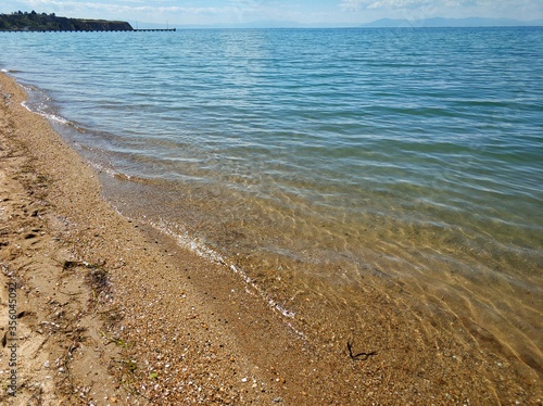 A stunning sandy beach in the area of Thessaloniki Greece. Blue summer sky with clouds.