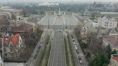 Budapest, Hungary - 4K drone flying above Andrassy avenue towards the beautiful Heroes Square and City Park (Varosliget) in the morning. Totally empty square due to 2020 coronavirus pandemic photo