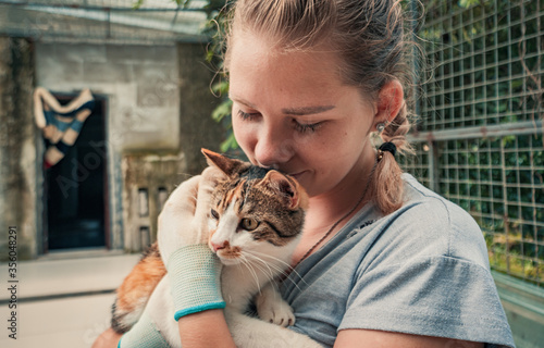 Quadro em tela Close-up of female volunteer holds on hands cat in shelter