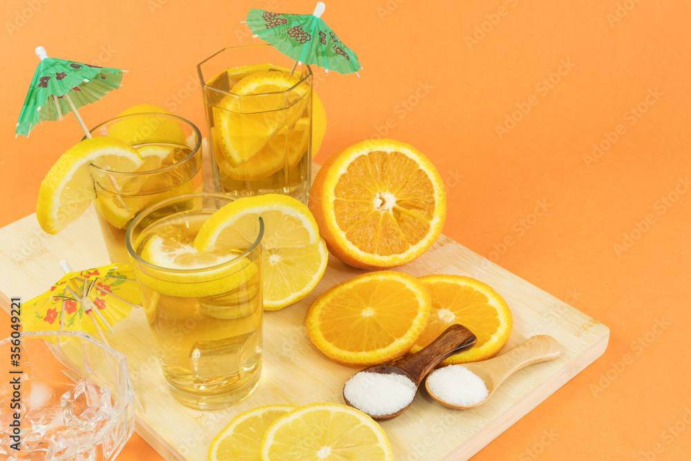 Glasses of cold tea with slices of orange and lemon Glasses of cold tea with slices of orange and lemon