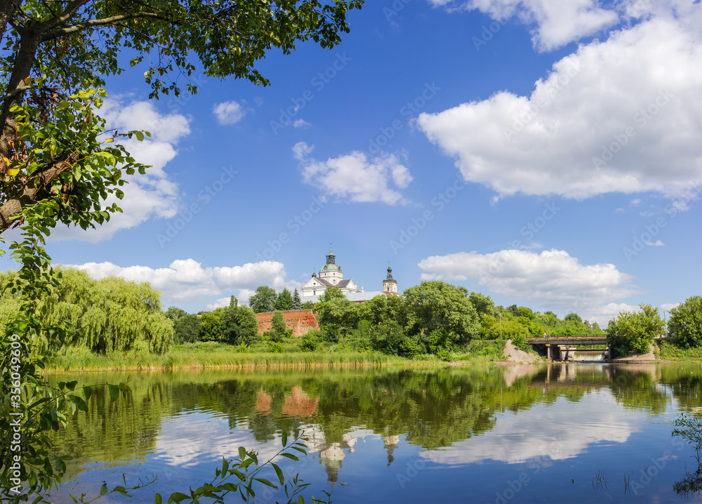 Medieval Discalced Carmelites monastery over river, general view, Berdychiv, Ukraine