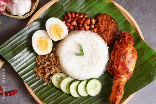 "Nasi lemak" is a Malay fragrant rice dish cooked in coconut milk and pandan leaf. It is commonly found in Malaysia. This nasi lemak with extra dish spices fried chicken.
