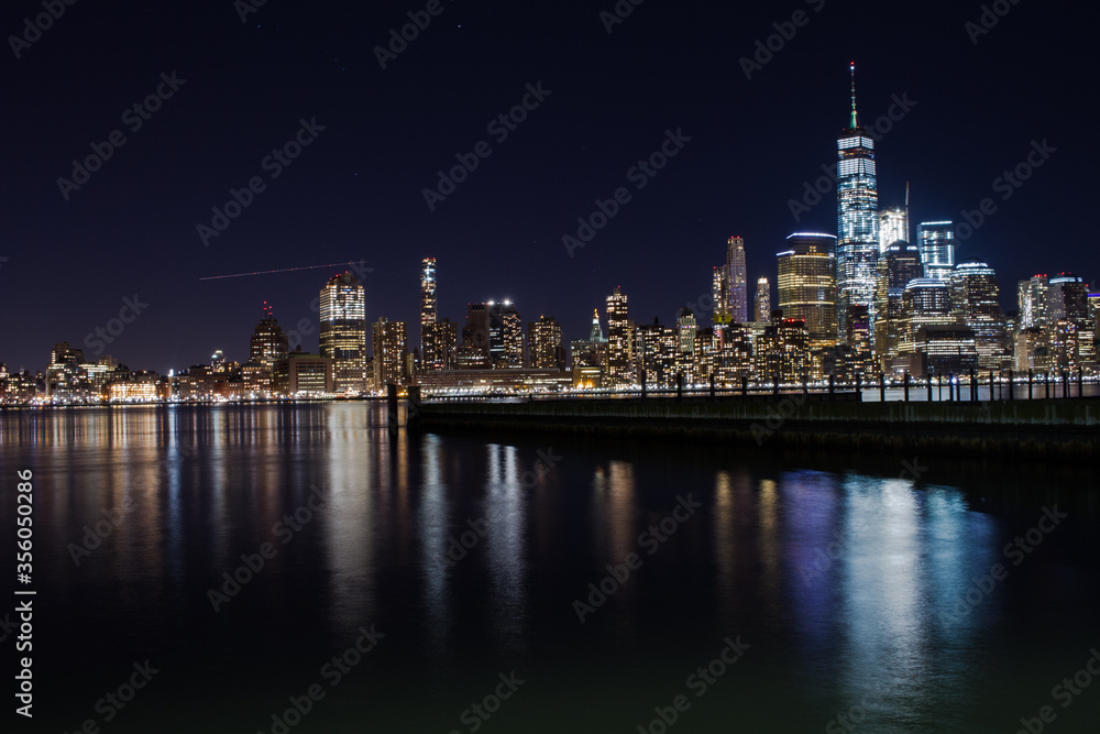 NEW YORK CITY, USA - december 25, 2017 skyline with reflection in cold winter night lake