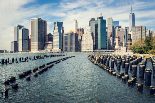 Old pier pylons and Downtown Manhattan  New York City.