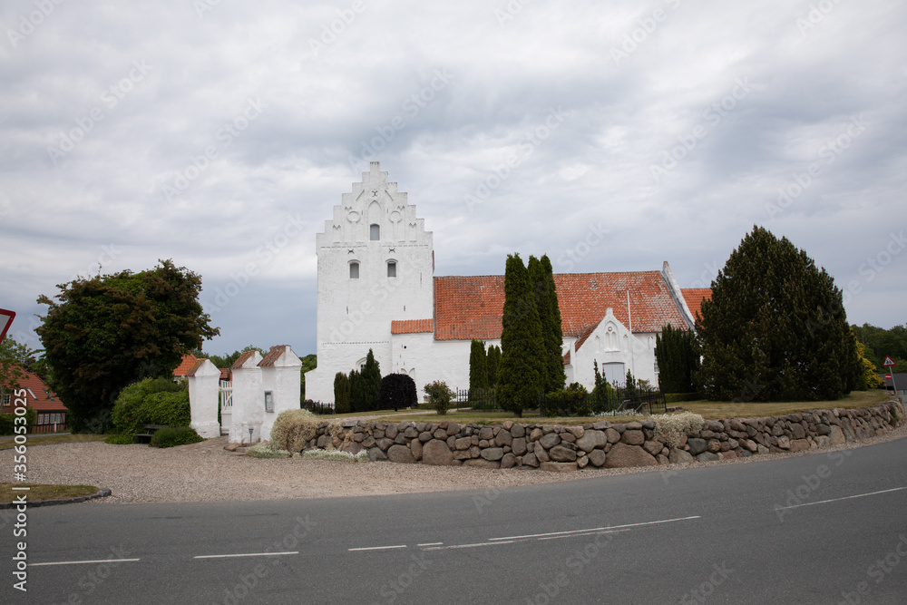 old danish white church with clouds