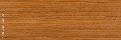 Natural brown teak veneer background for new exterior view. Natural wood texture, pattern of a long veneer sheet, plank.
