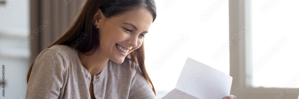 Happy girl read paper letter with good news horizontal photo banner for website header design. Hired career opportunity, student get scholarship, money refund, bank statement financial success concept Happy girl read paper letter with good news horizontal photo banner for website header design. Hired career opportunity, student get scholarship, money refund, bank statement financial success concept