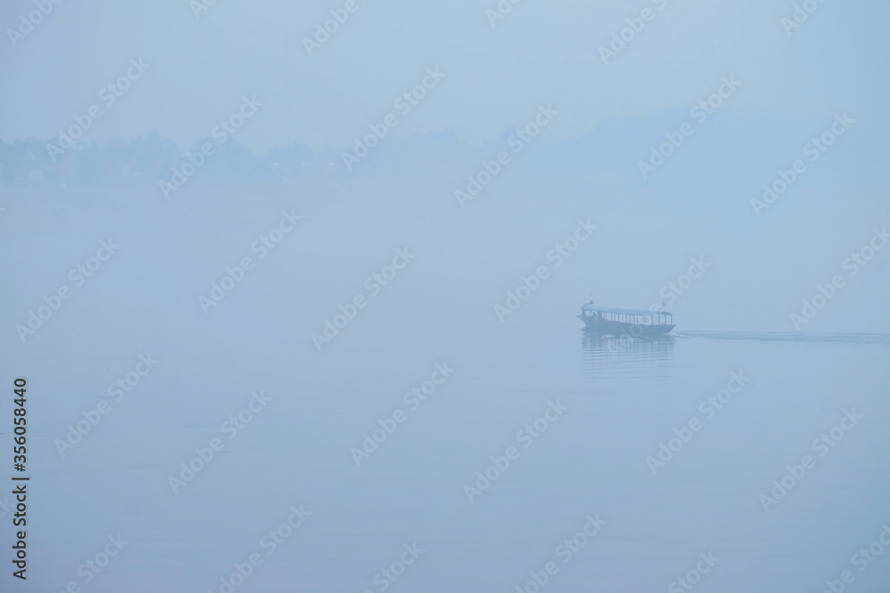 A boat on the Mekong River in the foggy morning in Chiang Khan, Loei Province