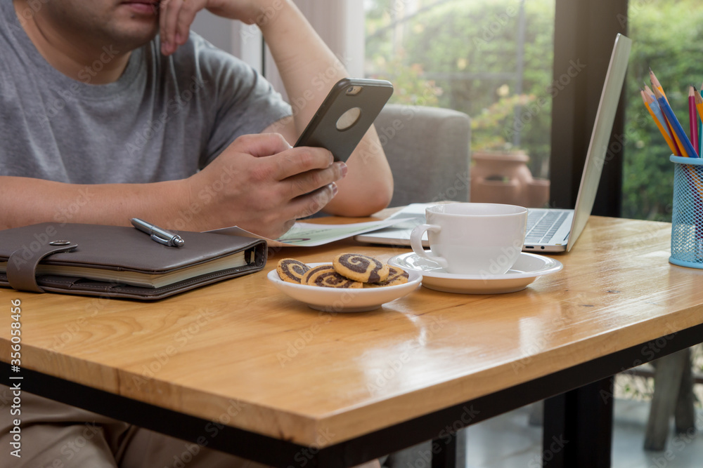 A young businessman sitting at a computer desk, Work from home and social concept. A young businessman sitting at a computer desk, Work from home and social concept.