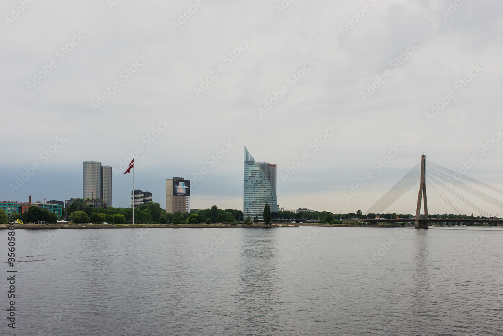 Naklejka premium Riga, Latvia - 11-06-2019: Riga river bank on a cloudy day, Latvia