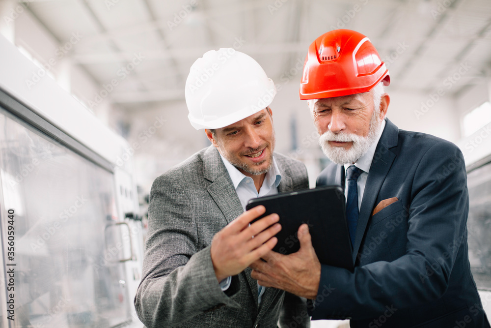 Colleagues working together. Arhitects in factory. Colleagues working together. Arhitects in factory.