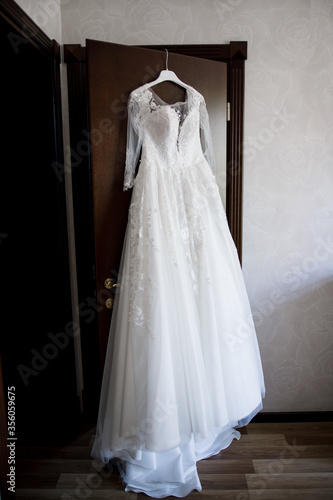 wedding dress hanging on the closet in the room