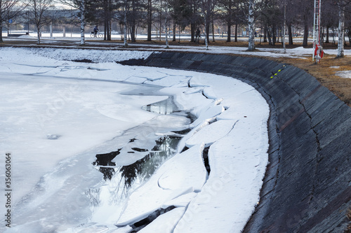 Melting ice on the lake shore photo