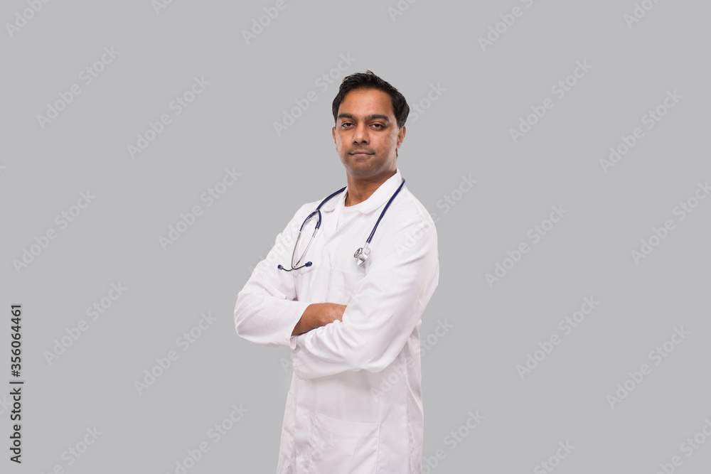 Indian Man Doctor not Smiling Hands Crossed Isolated. Healthy life, Medicine Concept. Indian Man Doctor not Smiling Hands Crossed Isolated. Healthy life, Medicine Concept.