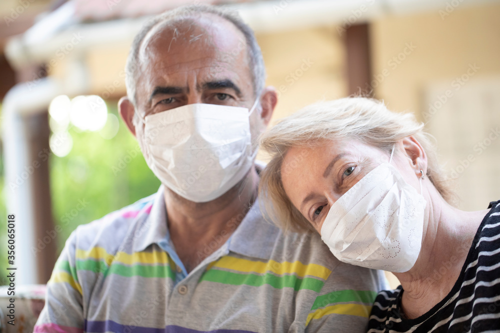 Senior couple posing with mask