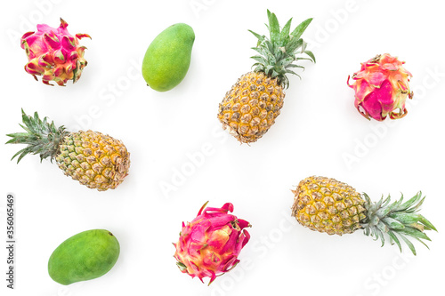 Tropical fruit pattern with pineapple, mango and dragon fruits isolated on white background. Flat lay, top view