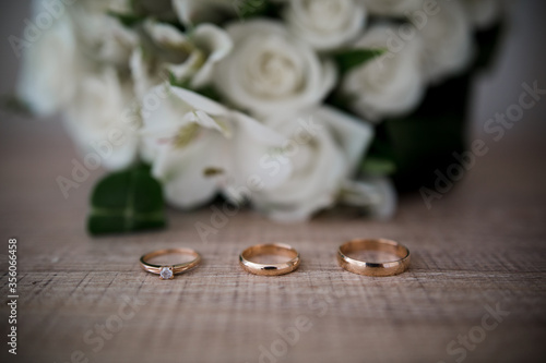 wedding gold rings near a bouquet