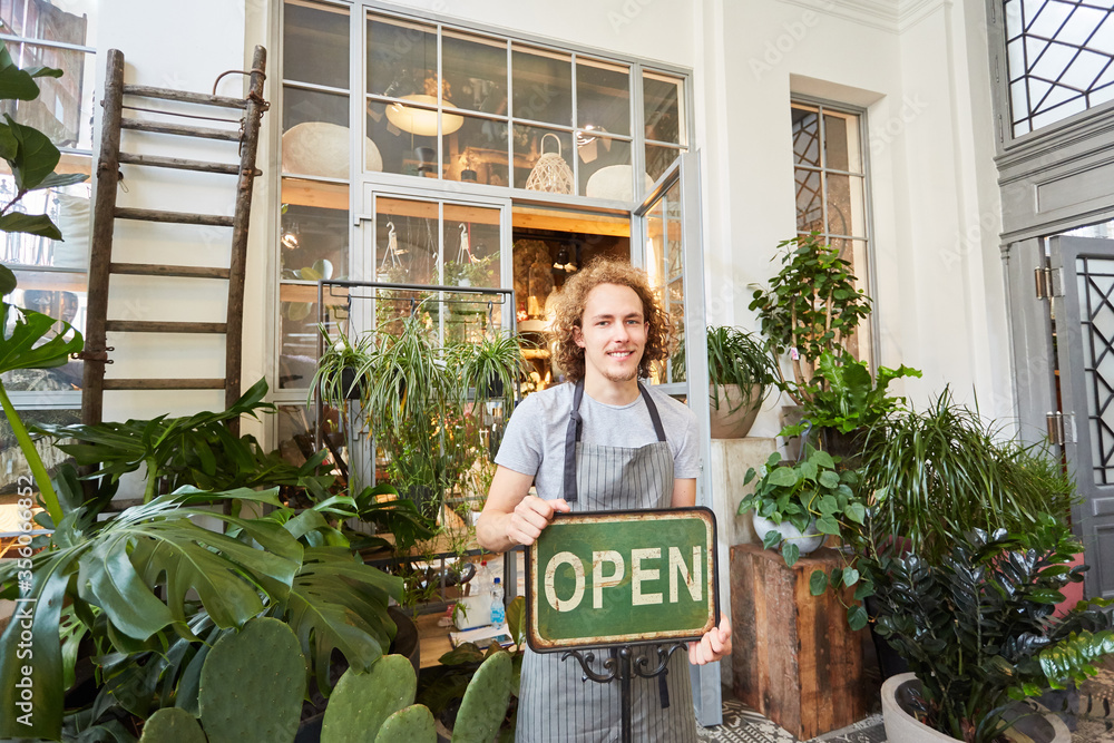 Florist with open sign for the opening of the garden center Stock Photo ...