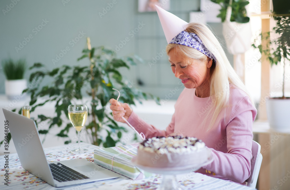 Senior woman with laptop indoors at home, celebrating distance birthday. Senior woman with laptop indoors at home, celebrating distance birthday.