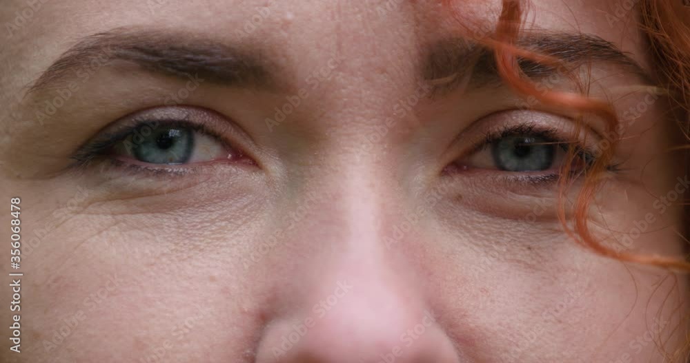 Close up of blue eyed young ginger attractive girl who is looking at camera and smiling Close up of blue eyed young ginger attractive girl who is looking at camera and smiling