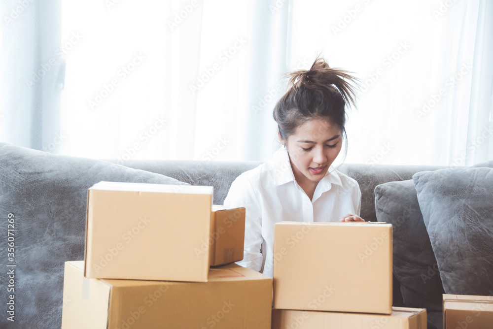 Woman packing and check address customers who order shopping online,work from home and delivery concept for COVID-19 prevention
Woman packing and check address customers who order shopping online,work from home and delivery concept for COVID-19 prevention