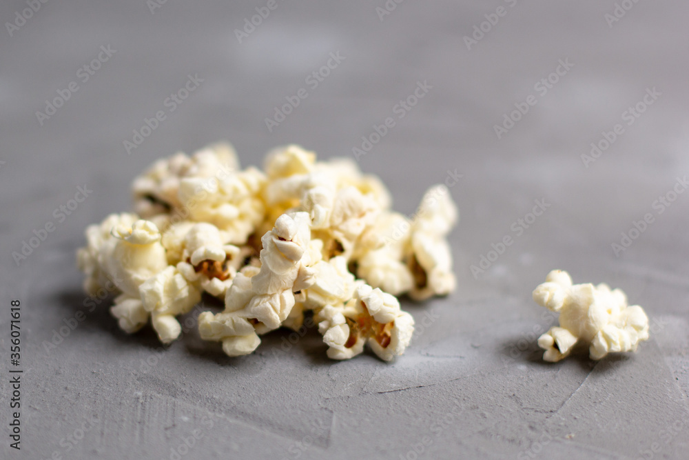 Pile of delicious fresh popcorn on grey background Pile of delicious fresh popcorn on grey background
