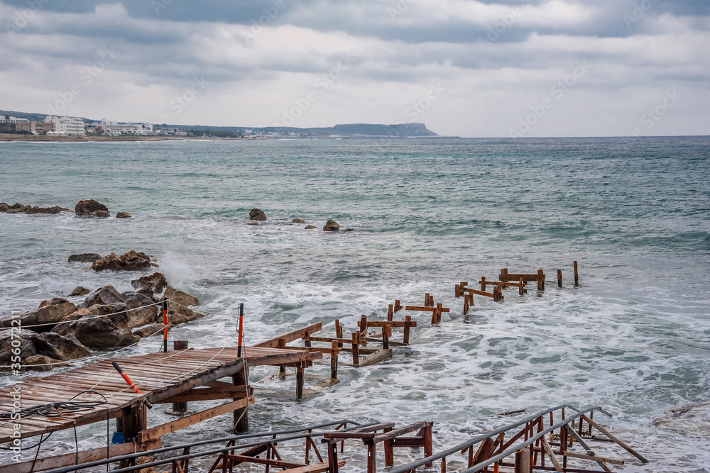 Metal bridge in the raging sea Metal bridge in the raging sea